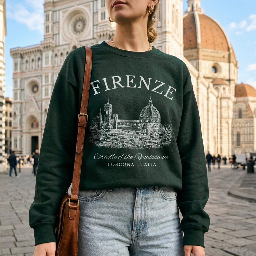 Person wearing a green sweatshirt with 'FIRENZE' and cathedral design, standing in front of a historic building.