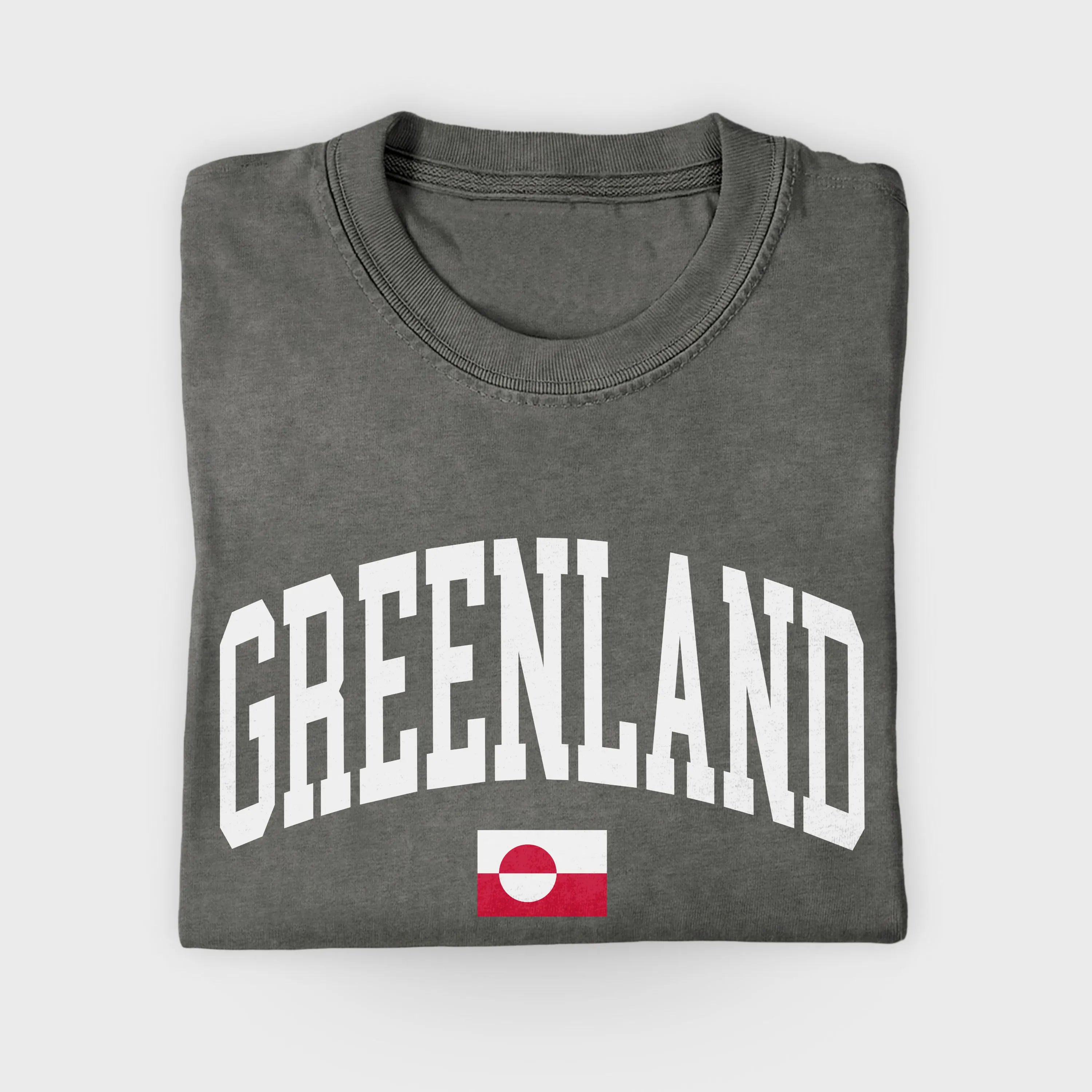 Folded gray t-shirt with 'GREENLAND' text and a flag on a light gray background